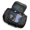Black Briggs & Riley travel duffel bag with clothes and items inside on a white background