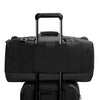 Black Briggs & Riley duffel bag on a white background