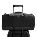 Black Briggs & Riley duffel bag on a white background