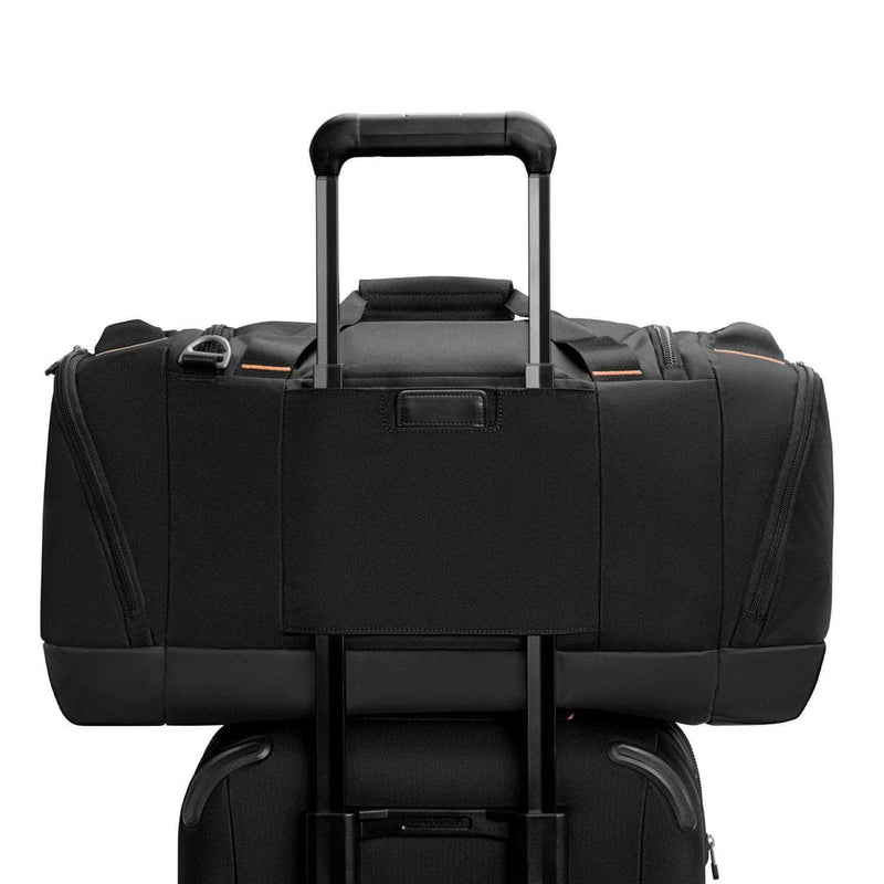 Black Briggs & Riley duffel bag on a white background
