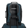 Back view of a blue Briggs & Riley backpack with visible branding on a white background