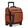 Orange Briggs & Riley rolling suitcase with black accents on a white background