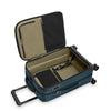 Open blue Briggs & Riley suitcase with beige interior on a white background