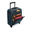 Blue Briggs & Riley suitcase with open compartment showing packed clothes on a white background