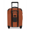 Orange Briggs & Riley suitcase with black accents on a white background