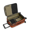 Open Briggs & Riley suitcase with black interior on a white background
