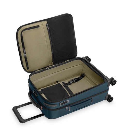 Open blue Briggs & Riley suitcase with beige interior on a white background