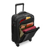 Black Briggs & Riley suitcase with open compartment showing various items on a white background
