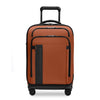 Orange Briggs & Riley suitcase with black accents on a white background