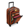 Orange Briggs & Riley suitcase with open compartment showing travel items on a white background