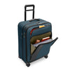 Blue Briggs & Riley suitcase with front pockets packed on white background