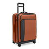Orange Briggs & Riley suitcase with black accents on white background