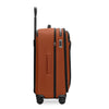 Orange Briggs & Riley suitcase with black accents on white background