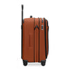 Orange Briggs & Riley suitcase with black accents on white background
