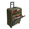green Briggs & Riley suitcase with front pockets loaded on a white background