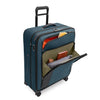 blue Briggs & Riley suitcase with front pockets loaded on a white background