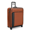orange Briggs & Riley suitcase on a white background