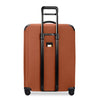 orange Briggs & Riley suitcase on a white background