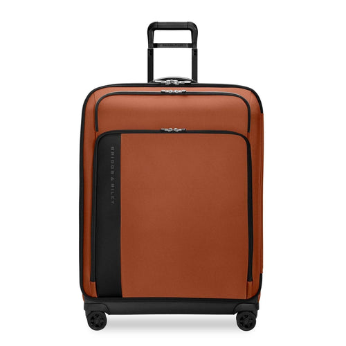orange Briggs & Riley suitcase on a white background