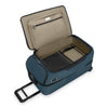 Open blue Briggs & Riley suitcase with beige interior on a white background