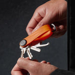 in hand tangerine Orbitkey Active Key Organizer