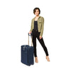 Model with navy Briggs & Riley Baseline Essential 2-Wheel Carry-On