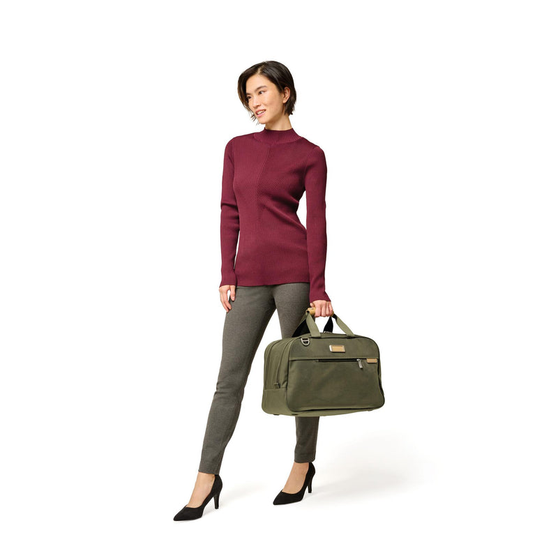 Model with olive Briggs & Riley Baseline Executive Travel Duffle