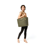 Model with olive Briggs & Riley Baseline Traveler Tote